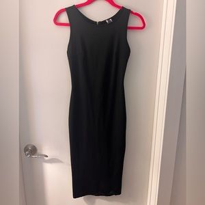 Fitted midi sleeveless black dress with gold zipper detail going down the back